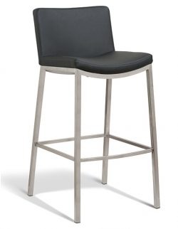 A modern bar stool with a black cushioned seat and backrest, supported by a sleek, metallic silver frame with four legs. The design includes a footrest near the bottom of the legs.