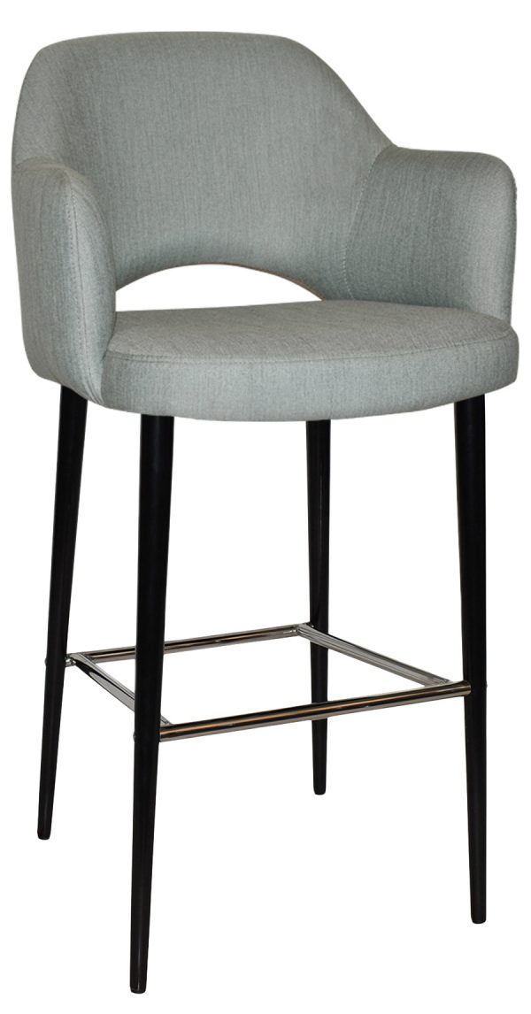 A modern bar stool with a grey upholstered seat and backrest. The stool has black, slim, tapered legs connected by a metal footrest. The backrest curves slightly for added comfort.