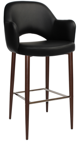 A sleek, modern bar stool with a black faux leather seat and backrest. The stool has four slender wooden legs with a slightly tapered design, supported by a brushed metal crossbar footrest. The seat has curved armrests for added comfort and style.