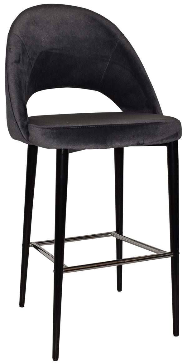 A modern bar stool with a black velvet upholstered seat and backrest, featuring an open lower back design. It has slim black metal legs with a footrest bar connecting the front and back legs for added stability and comfort.