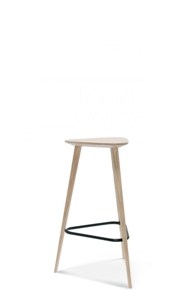 A minimalist wooden bar stool with three slim legs and a triangular seat. The legs are light wood, tapering towards the bottom, and a black metal footrest connects two of the legs. The design is sleek and modern. The background is plain white.