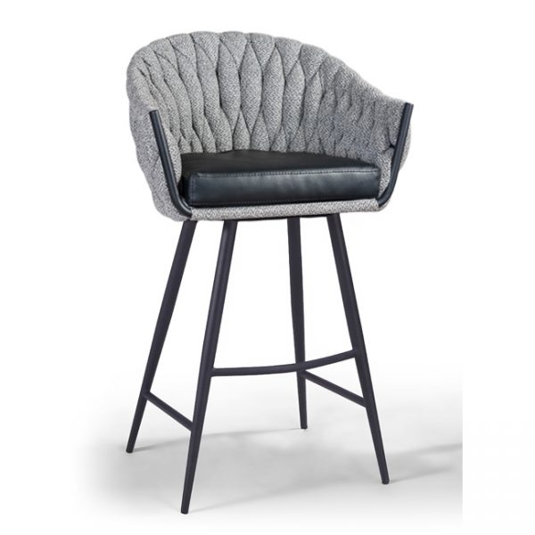 A modern bar stool with a padded, textured gray backrest and a black cushioned seat. The stool features a sleek metal frame with four angled legs and a footrest for support. The design combines contemporary and cozy elements.