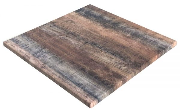 A square wooden tabletop with a weathered and distressed finish, displaying various shades of brown and gray. The surface has visible wood grain and texture, giving it a rustic and aged appearance.