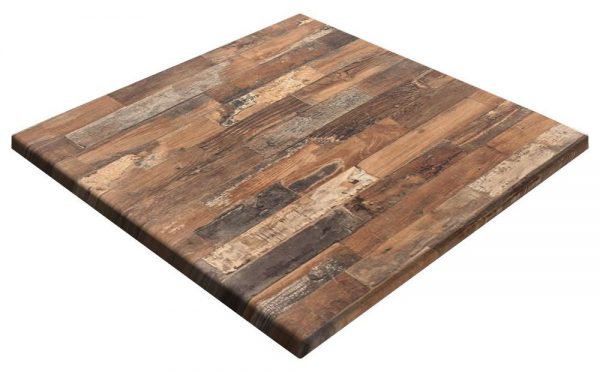 A wooden tabletop with a rustic, weathered appearance. The surface features various shades of brown and grey planks arranged in a staggered pattern, giving a reclaimed wood look. The edges are slightly beveled, adding to the overall aesthetic.