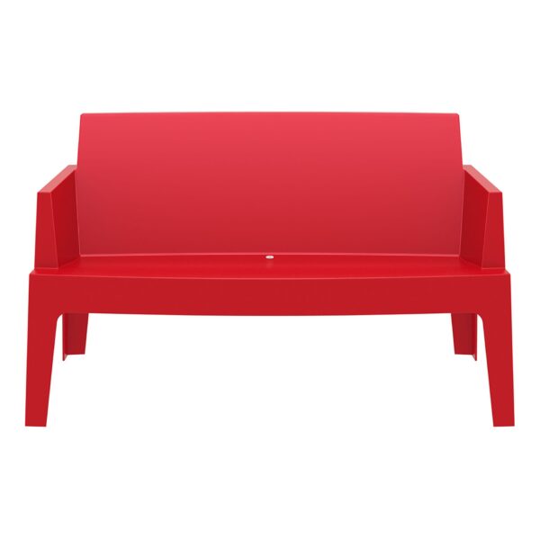 The Box Sofa is a red outdoor bench featuring a modern and minimalist design. It boasts clean lines, a flat backrest, and four sturdy legs made from plastic. The seat includes a small circular hole, likely for drainage purposes.