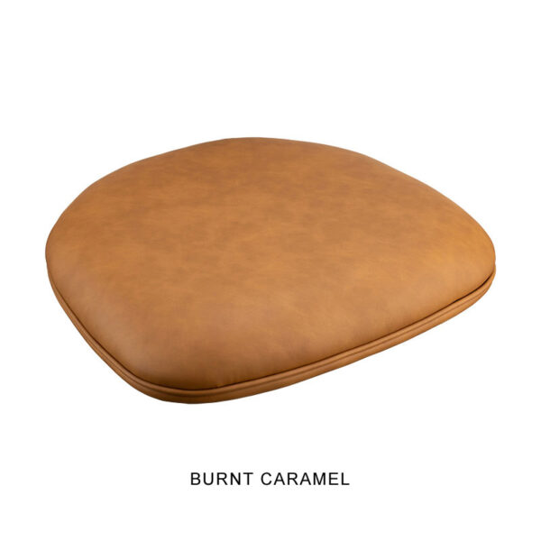 A close-up of the cushioned seat pad on the Bon Bon Chair in "Burnt Caramel" color. The seat pad is round with gently rounded edges and appears to be crafted from a smooth, leather-like material.