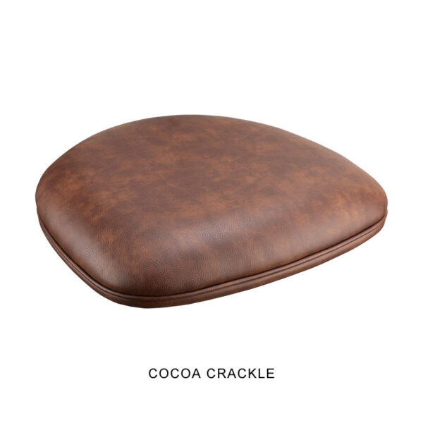 The Bon Bon Chair features a curved, padded seat cushion covered in brown faux leather with a textured, crackled finish. The text "COCOA CRACKLE" is written below the cushion, indicating the color and pattern name.